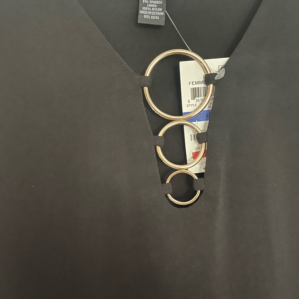 Black knit shirt with gold rings at the top